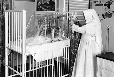 nurse caring for a baby during the 1918 flu epidemic