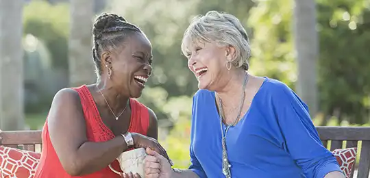 two senior women laughing