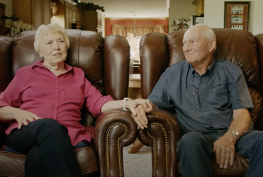 Grateful Patients holding hands in their living room