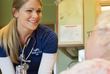 female nurse checking on patient